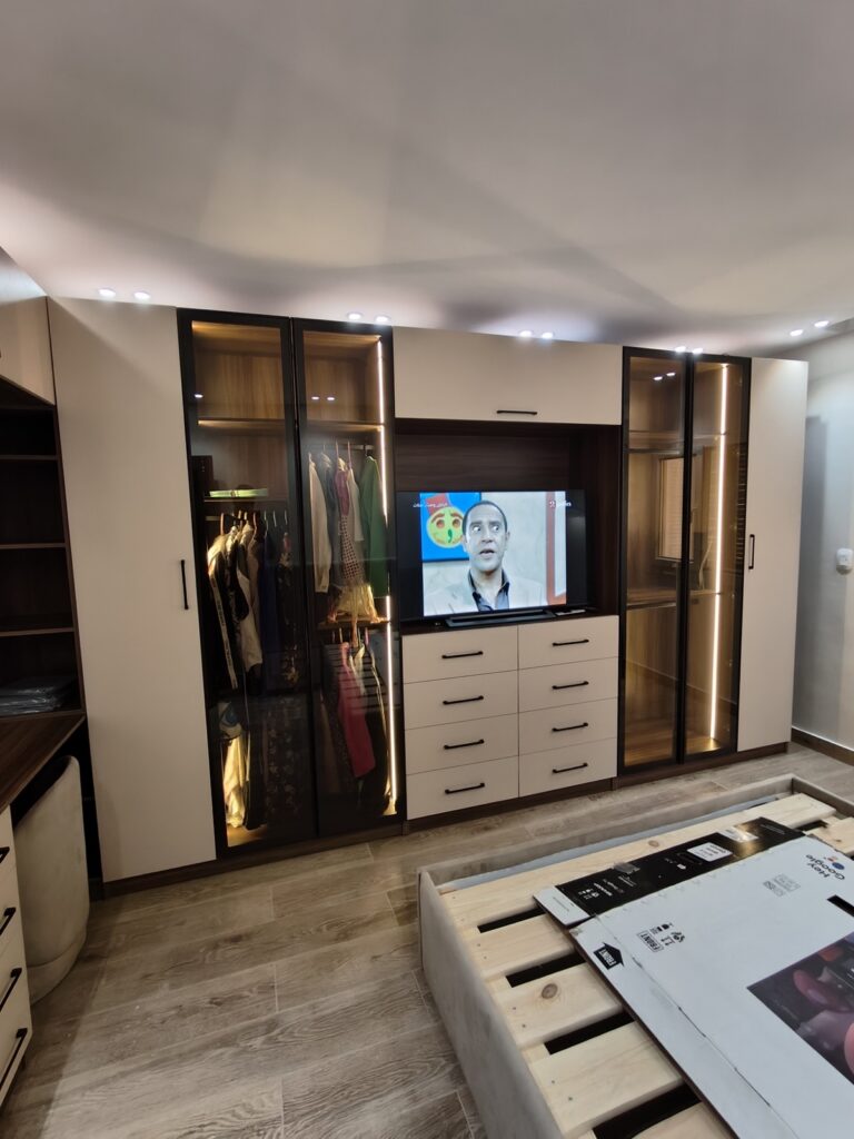 Additional angle of a custom master bedroom storage installation by Topniture.